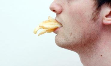 A man with chips in his mouth