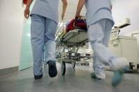 Nurses pushing hospital bed