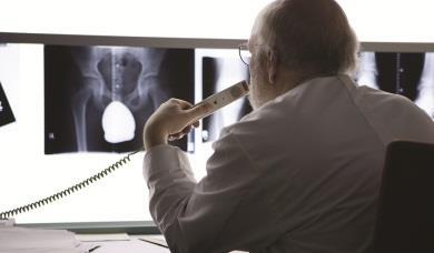 Doctor on phone looking at xrays