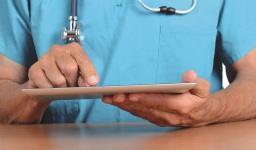 Doctor using tablet computer