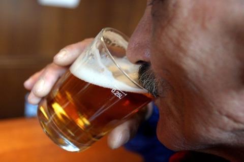 Older man drinking beer