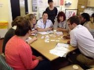 Group of people round a table, at work, talking