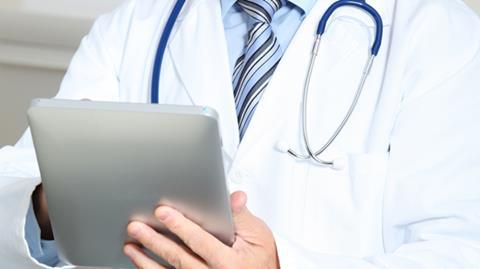 Doctor using electronic tablet device