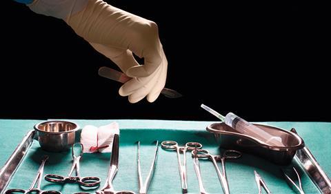 Surgeons hand reaching for scalpel