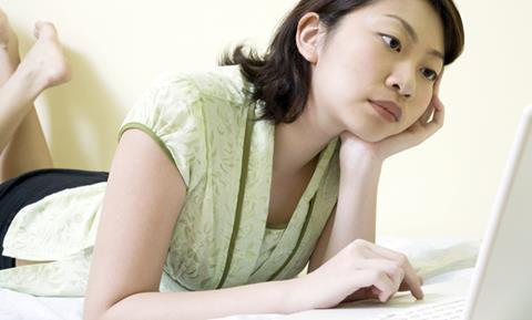 Teenager using computer alone