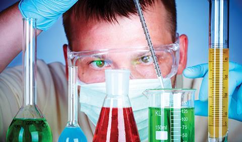 Man lookng closely at research chemicals