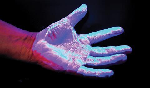 Hand hygiene: A hand under ultraviolet light to hightlight dirt