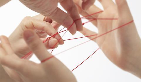 Cats cradle played by two people