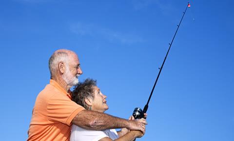 Older man and woman fishing