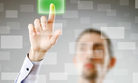 A man pressing a green spot on glass. Conceotual technology image