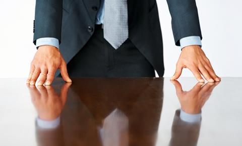 Man leaning on board table