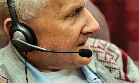 Older man with headset on using skype