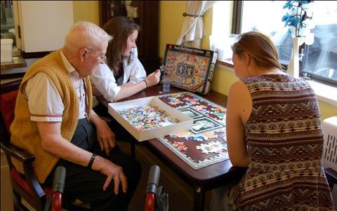 Volunteers do puzzle in Kissing It Better project