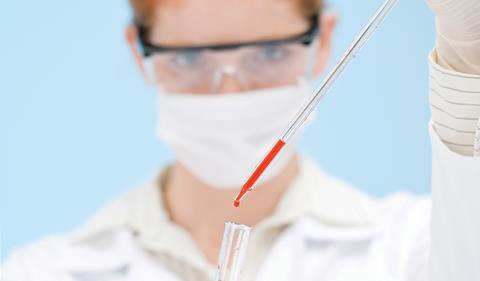 Woman with pipette doing medical research