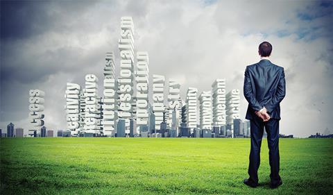 Businessman looking at city skyline which includes leadersip phrases such as 