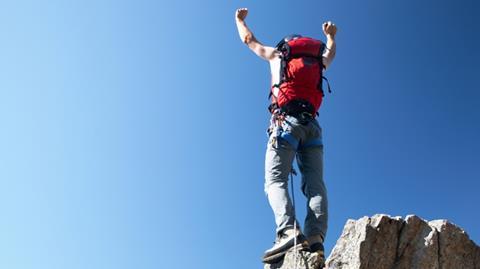 Man at top of mountain