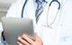 Doctor using electronic tablet device
