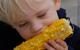 Boy eating corn