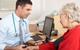 GP taking patient's blood pressure