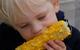 Boy eating corn