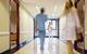 Blurred hospital corridor with three figures in it